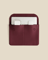 Laptop sleeve with charger and adapter inside pockets.