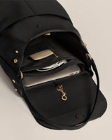 Open backpack with a laptop, wallet, and a keychain inside.