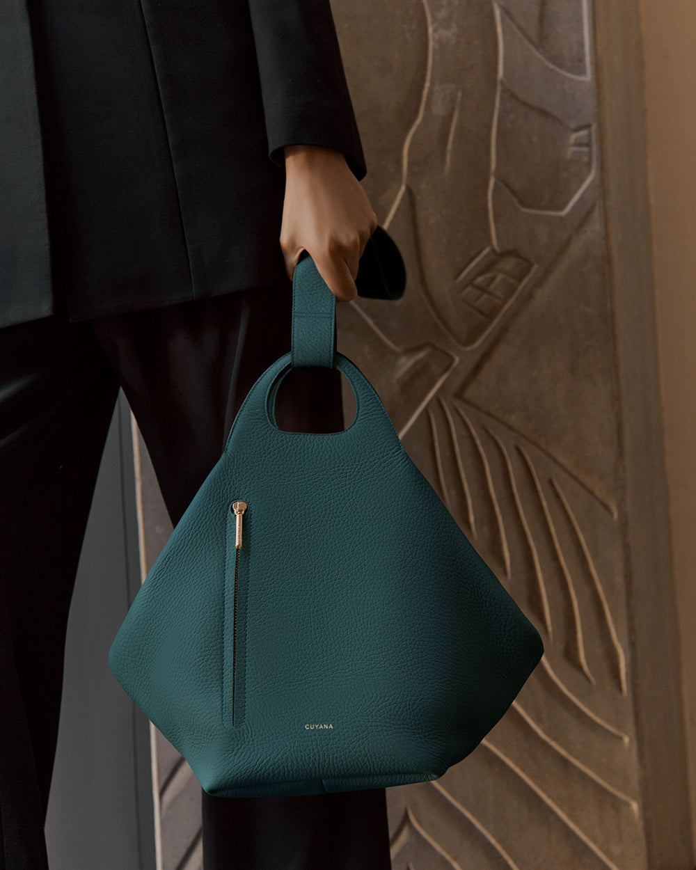 Oversized Paloma Bag Person holding a structured handbag with a zipper pocket