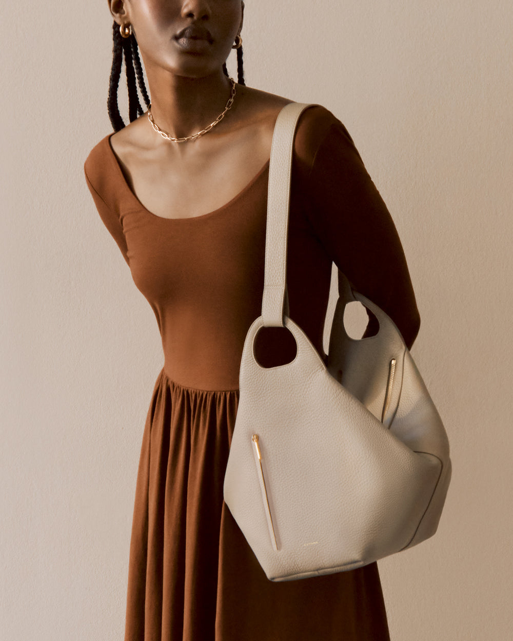 Oversized Paloma Bag Person in a long dress holding a handbag on shoulder