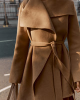 Close-up of a person wearing a belted coat.