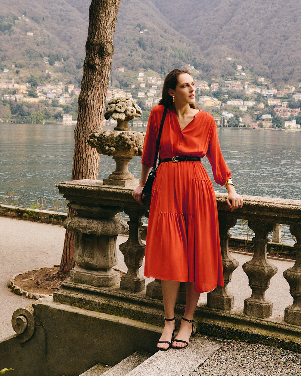 Tencel Gathered Panel Dress Woman in a dress standing by a railing overlooking a lake and hills.