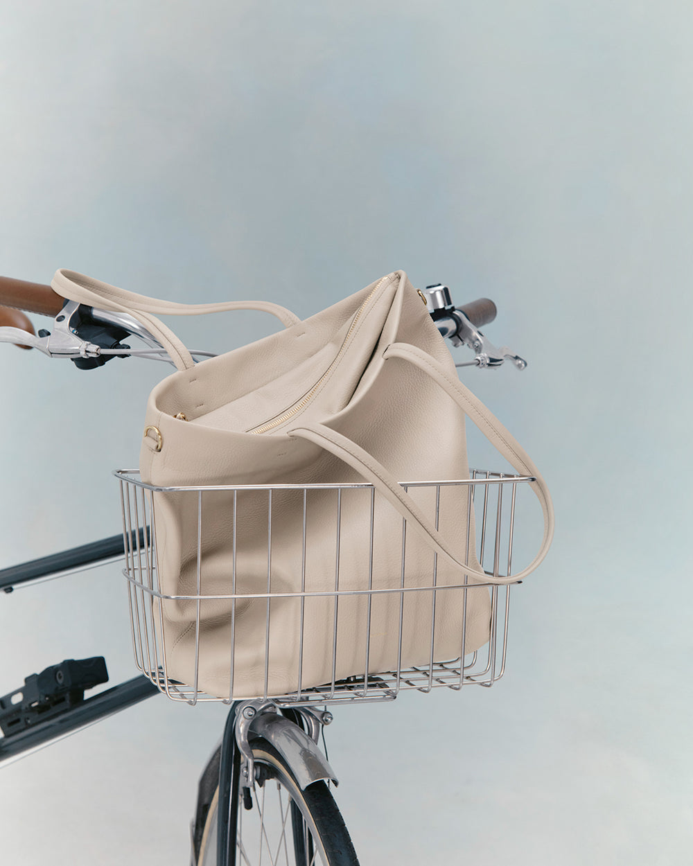 Tall Easy Zipper Tote Bicycle with a bag in the front basket against a plain background.