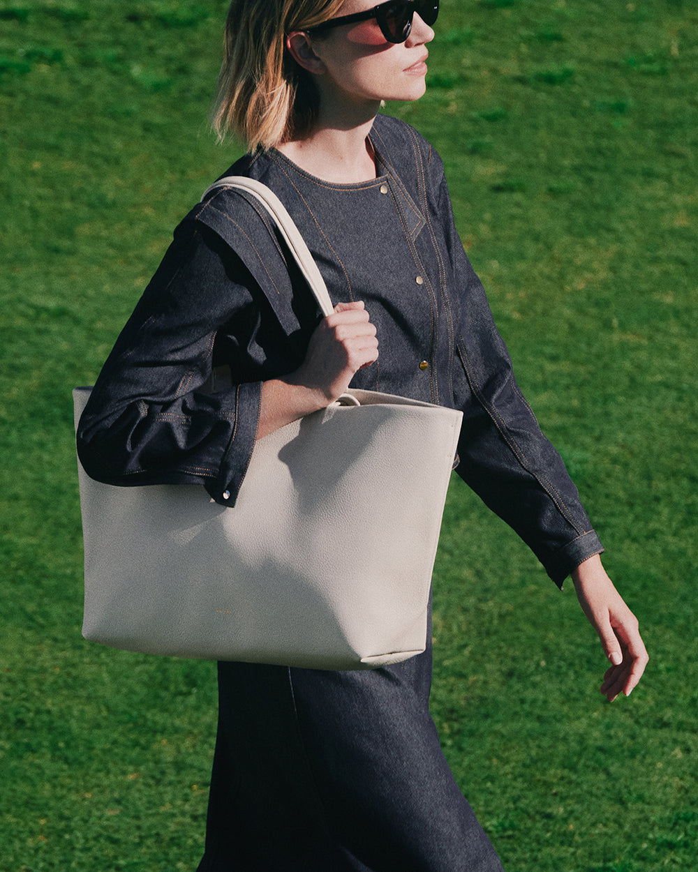 Classic Easy Tote Person with large shoulder bag walking on grass
