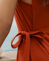 Close-up of a tied sash dress against a background with water