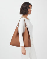 Woman carrying a large tote bag, looking to the side