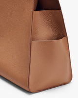 Close-up view of a textured bag with an external pocket.