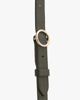 Belt with a circular buckle and loop detail.
