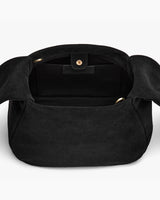 Open handbag viewed from the top showing inner compartment.