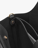 Close-up view of an open handbag showing inner compartments.