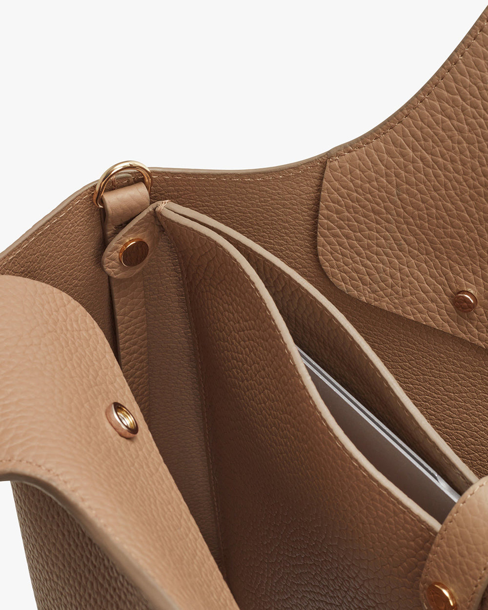 Close-up of an open handbag with visible interior and fasteners.
