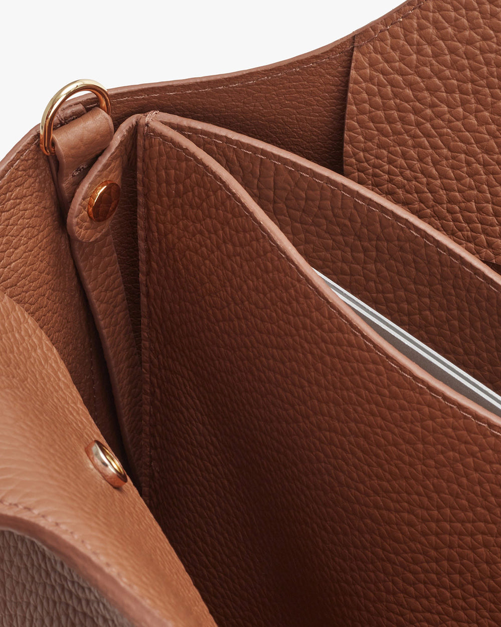 Open handbag showing interior compartments and zipper.