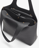 Open top handbag with handles and a shoulder strap.