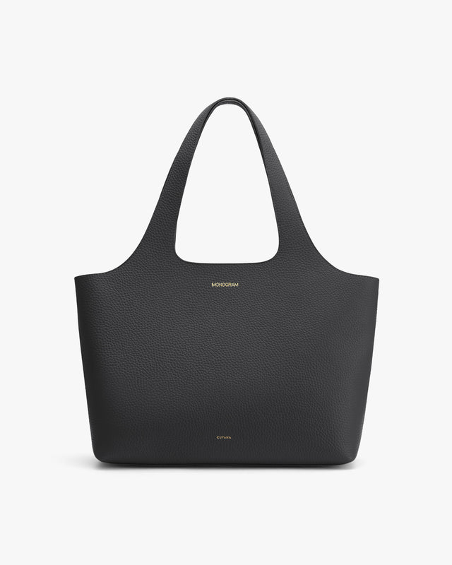 Large tote bag with two handles and a textured surface.