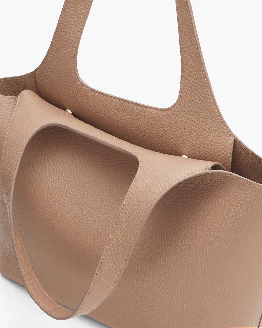 Close-up view of a textured handbag with handles.