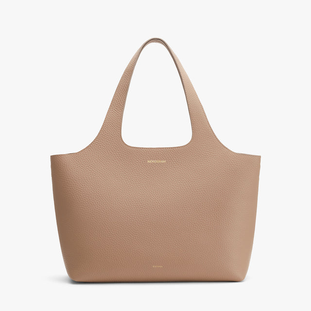 Leather tote bag on a plain background.