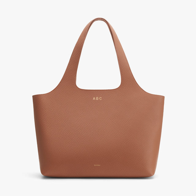 Personalized tote bag with initials 'ABC' embossed on it.