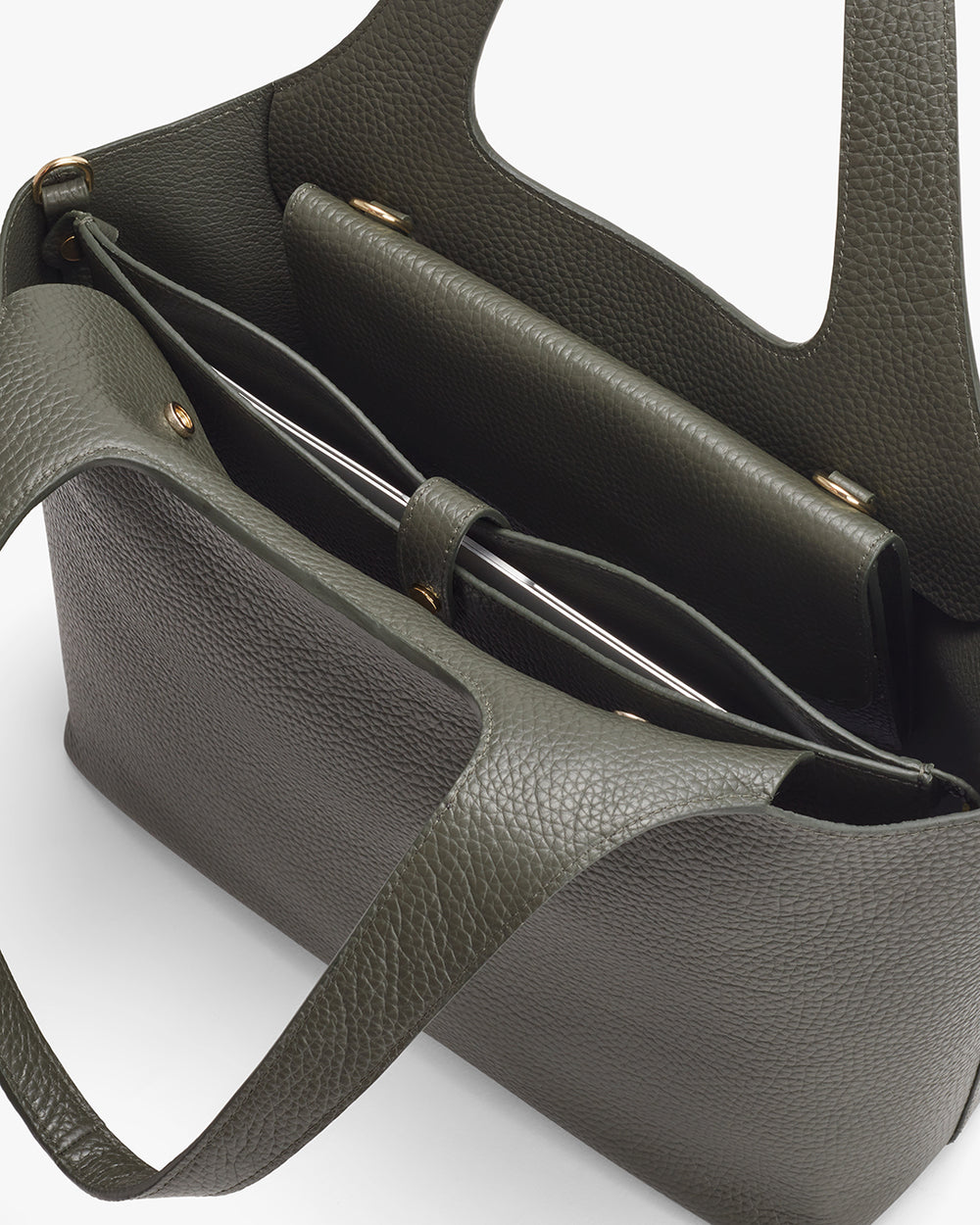 Overhead view of an open handbag with visible compartments.