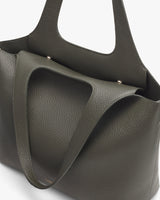 Leather tote bag with two handles visible.