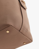 Close-up of a corner of a travel bag with metal studs