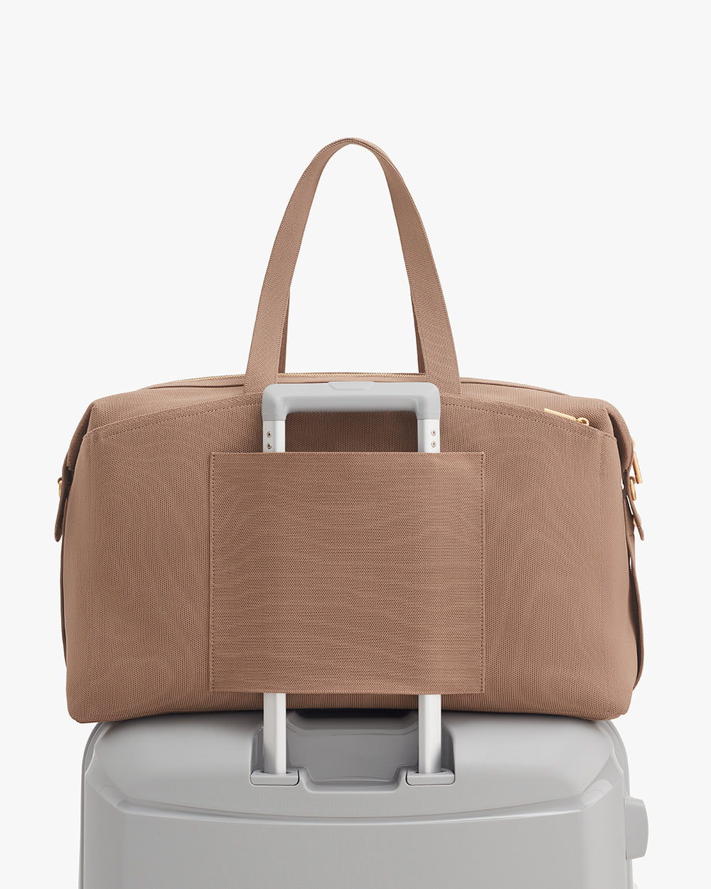 Weekender Bag (Recycled Knit) Travel bag attached to luggage handle.