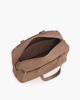 Open travel bag with zipper and handles on white background.