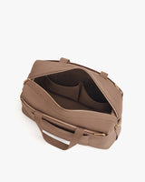 Open travel bag with interior compartments and shoulder straps.