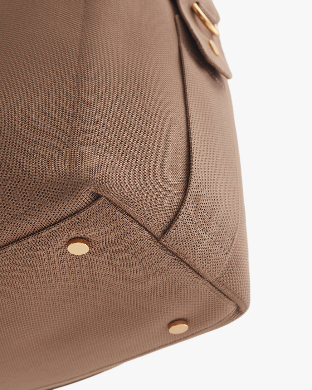 Overnight Bag (Recycled Knit) Close-up of a travel bag with metal studs and a pocket flap.