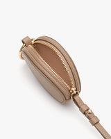 Small oval purse with zipper and attached strap.