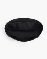 Open fabric handbag viewed from above showing the interior.