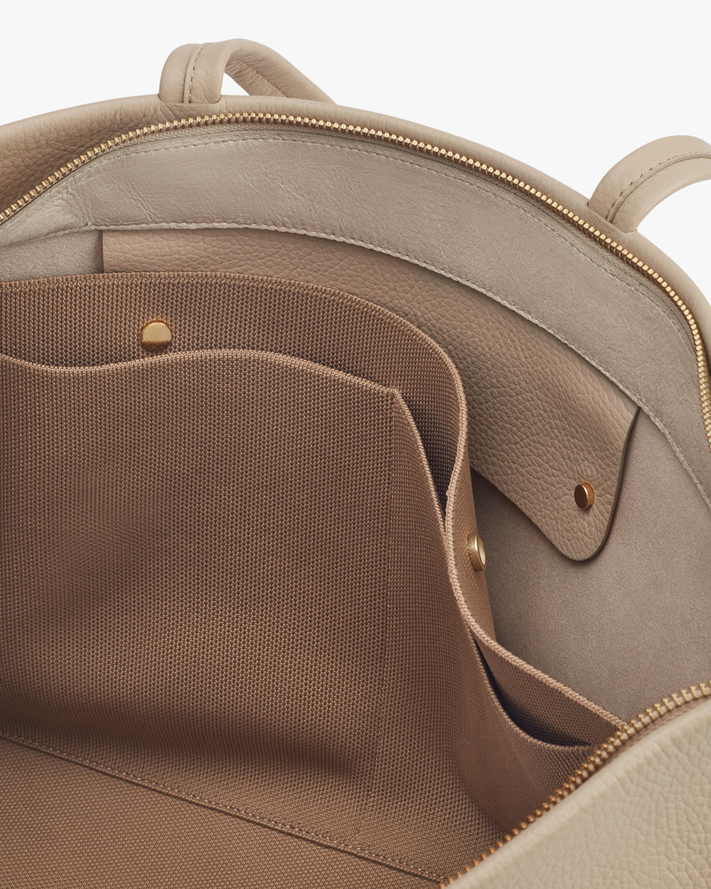 Close-up of an open backpack with visible pockets and zippers.