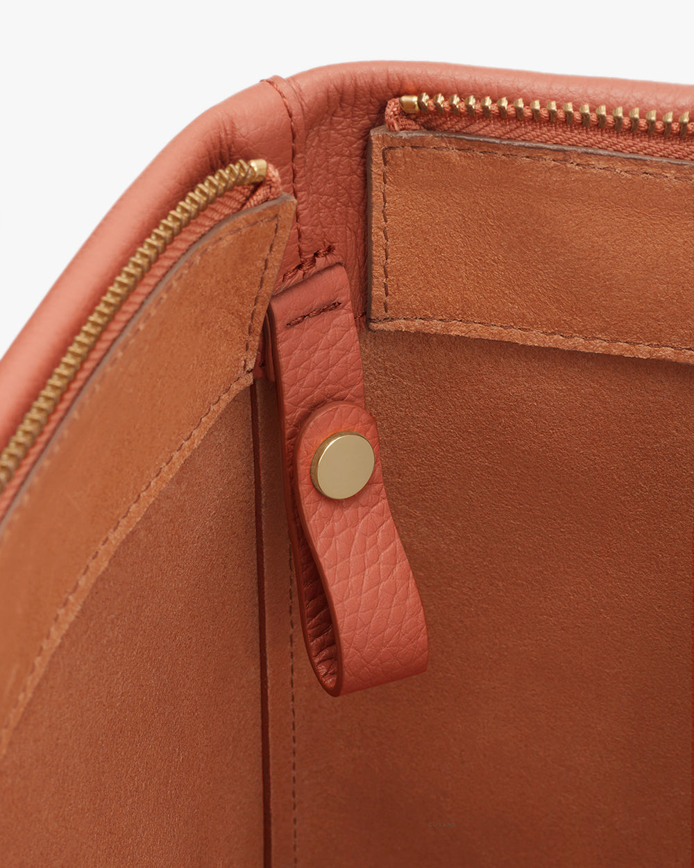 Classic Easy Zipper Tote Close-up view of a leather bag with zipper and snap button details.