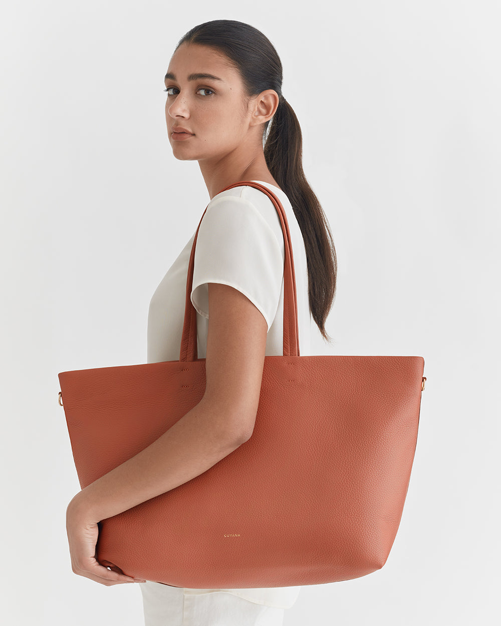 Classic Easy Zipper Tote Woman holding a large tote bag on her shoulder.