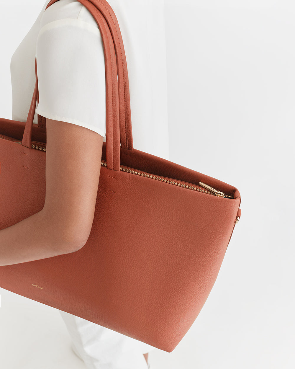 Classic Easy Zipper Tote Person holding a handbag over their shoulder