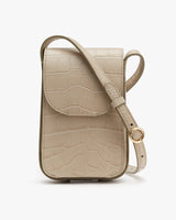 Small crossbody bag with a textured pattern and a circular buckle on the strap.