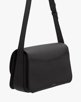 A shoulder bag with a flap and adjustable strap.