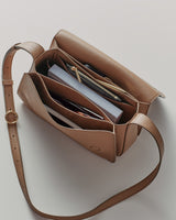 Open handbag with books and a wallet inside.
