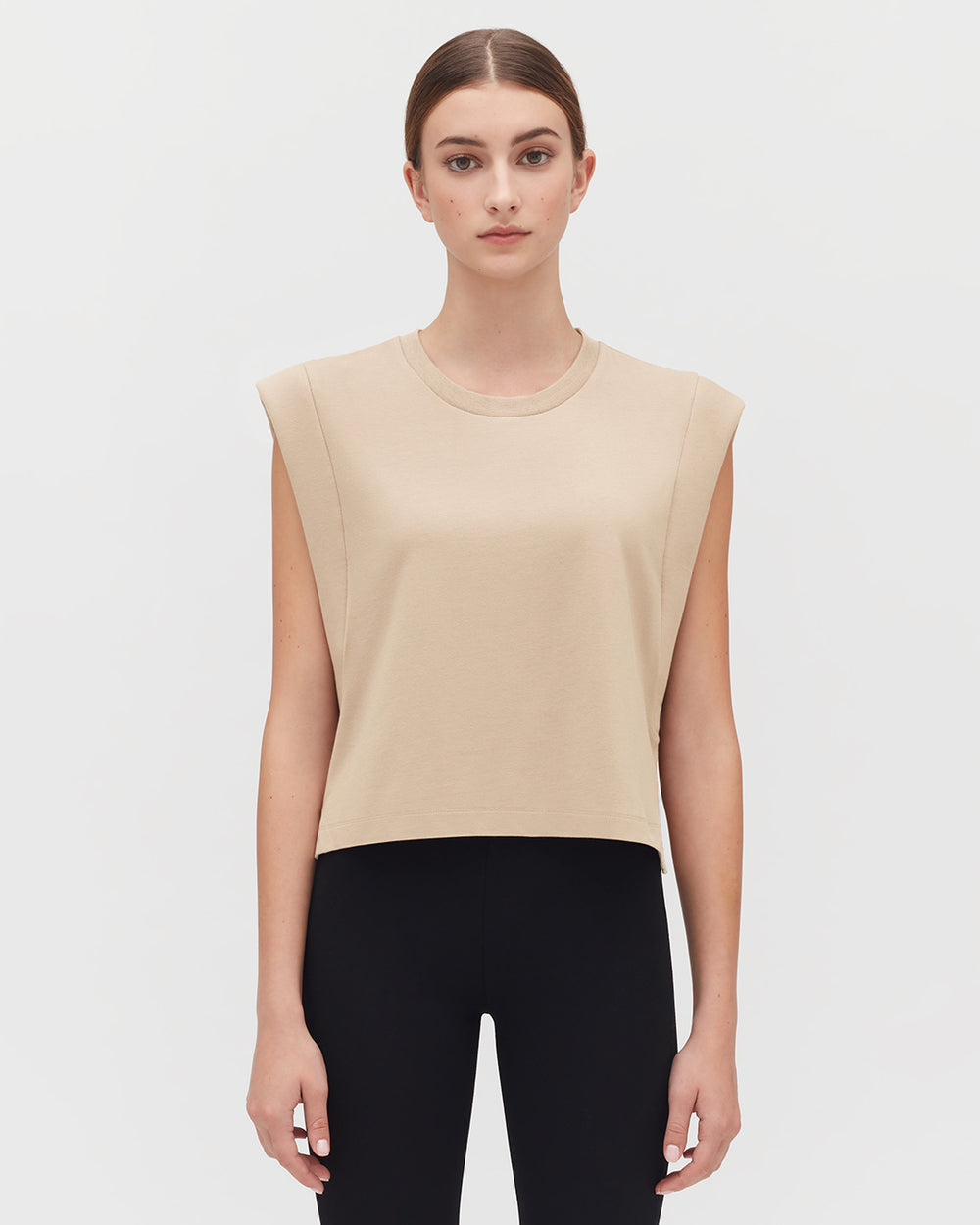 Cropped Tank Woman in sleeveless top and pants standing facing forward.