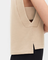 Woman wearing a sleeveless top with a V-neckline and a back view.