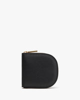 Small rounded zippered wallet standing upright on a plain background.