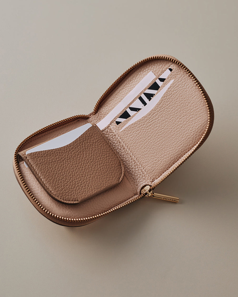 Open wallet with cards inside placed on a plain surface.
