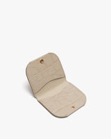 Open small textured wallet with visible snap fasteners.