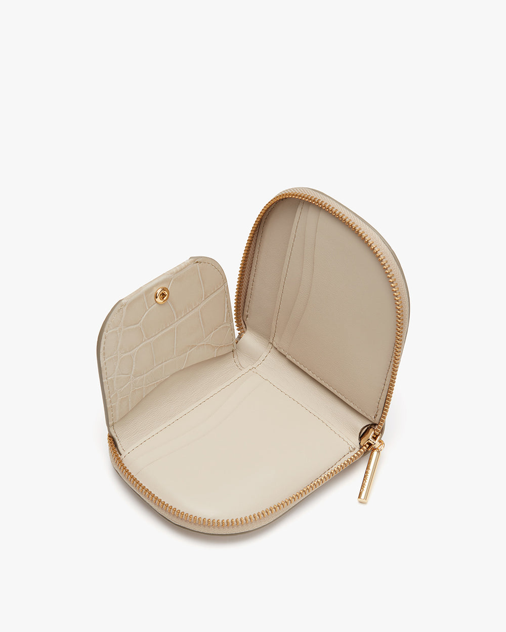 Open small heart-shaped case with zipper and interior pockets.