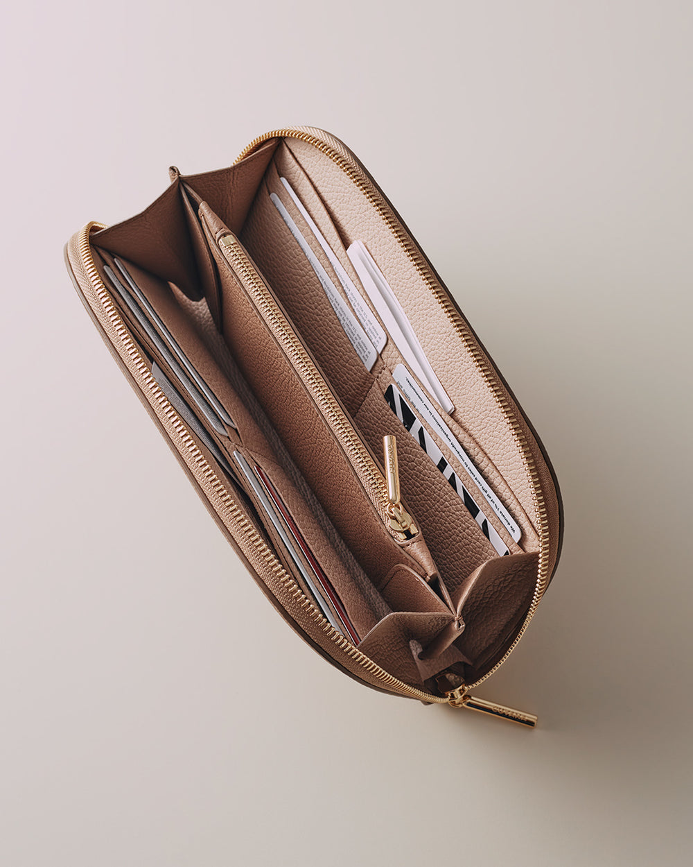 Open pencil case with various writing instruments inside.