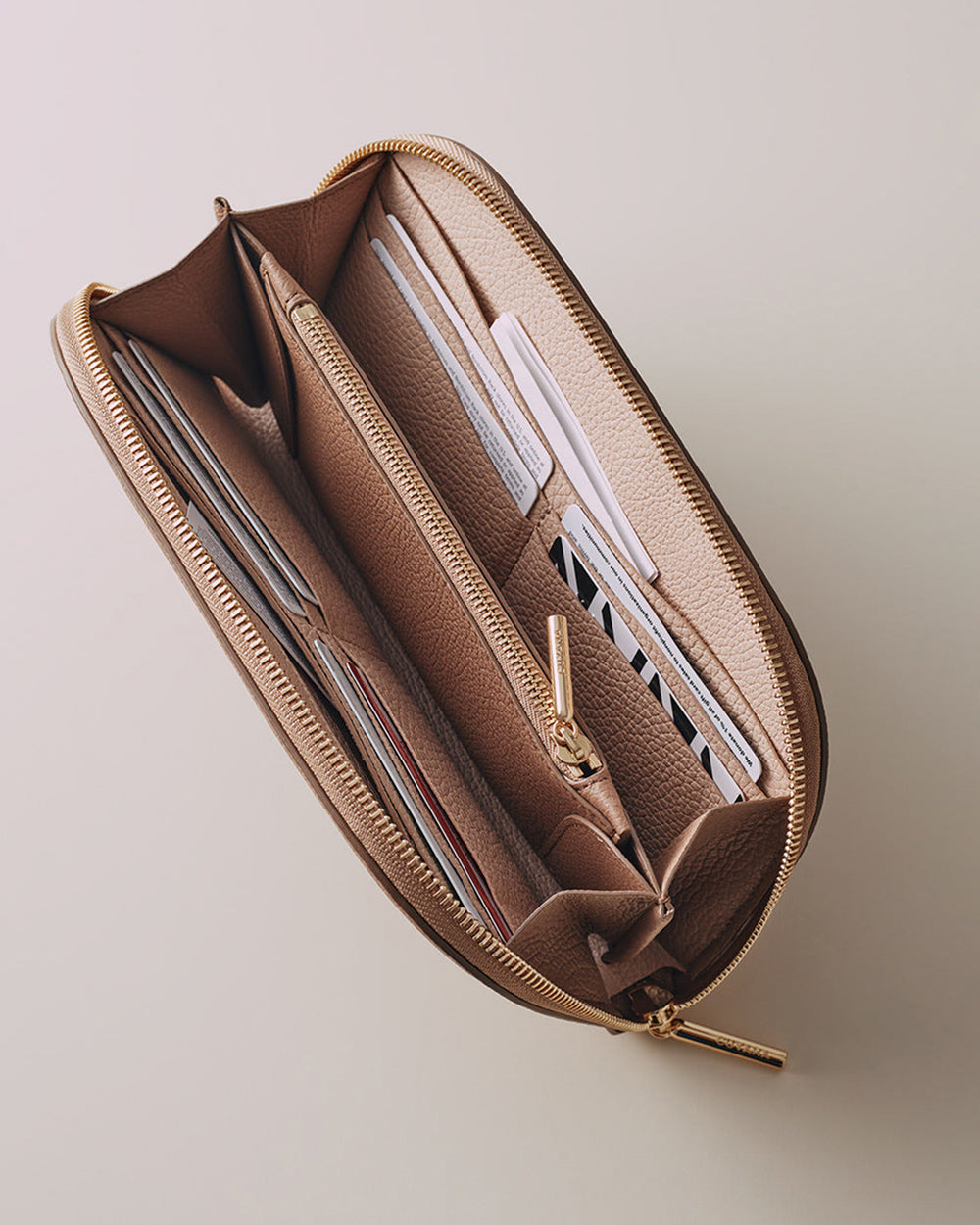 Open pencil case with various writing instruments inside.