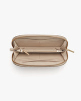 Open handbag viewed from above showing interior compartments and zippers.