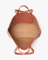 Open handbag viewed from the top, showing interior structure.