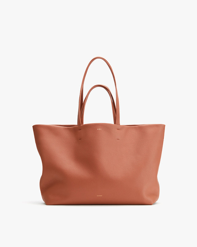 Large leather tote bag with two handles.