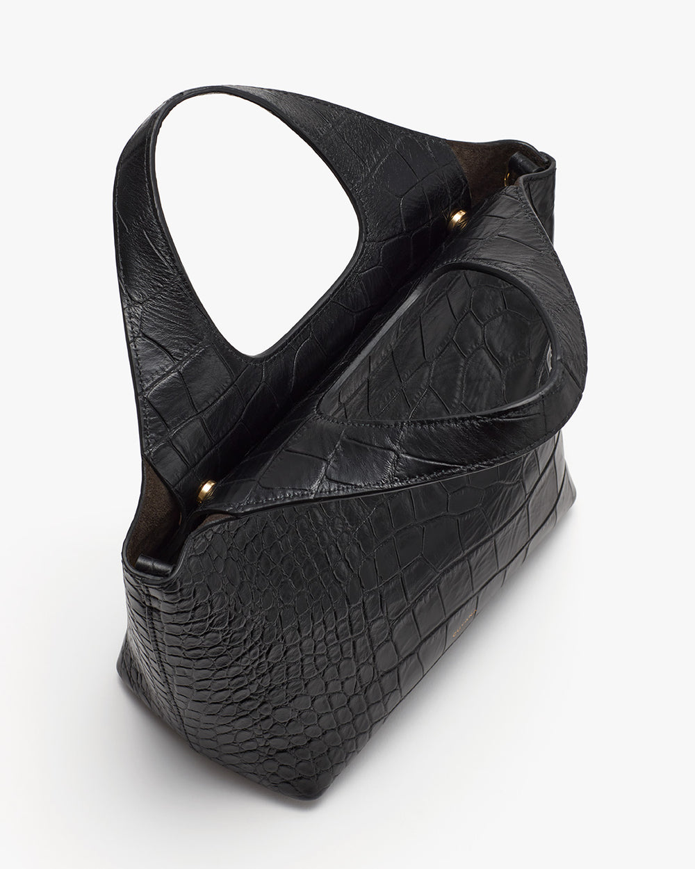 Handbag on a plain background with a single strap and textured surface.