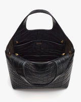 Open croc-embossed leather handbag with a single handle.